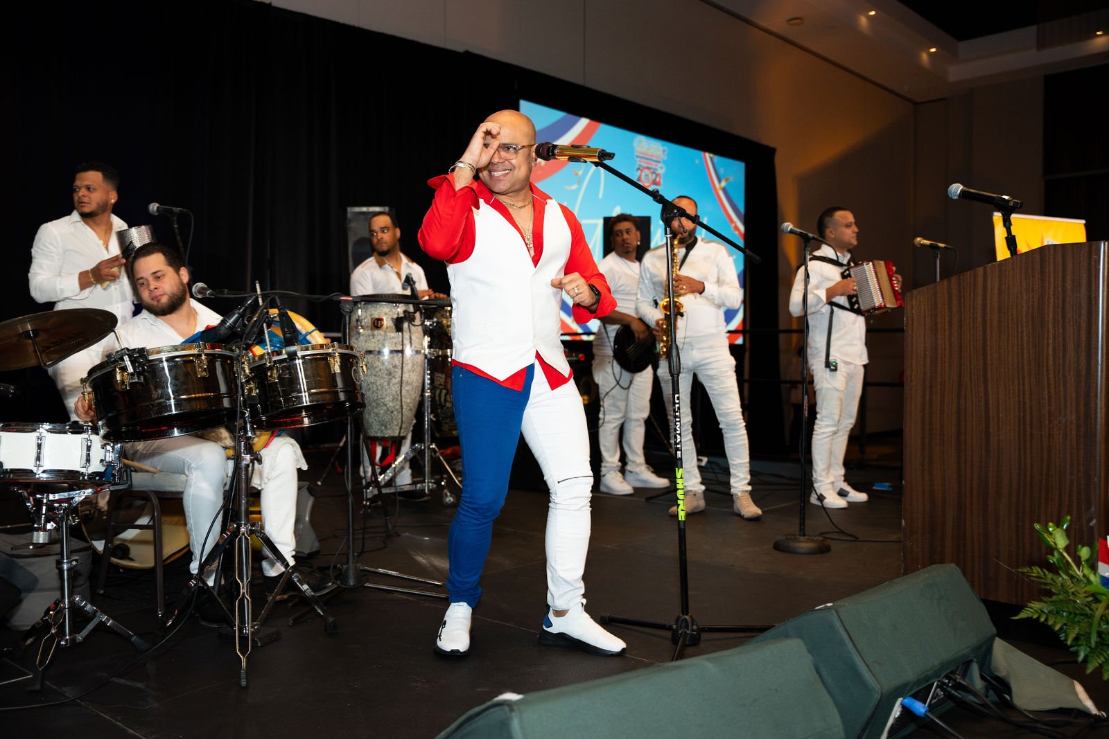 A singer performs with musicians on stage