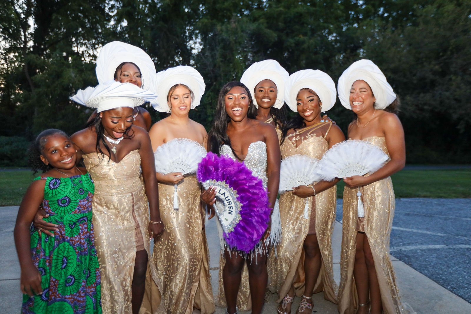 A wedding party poses together with bouquets