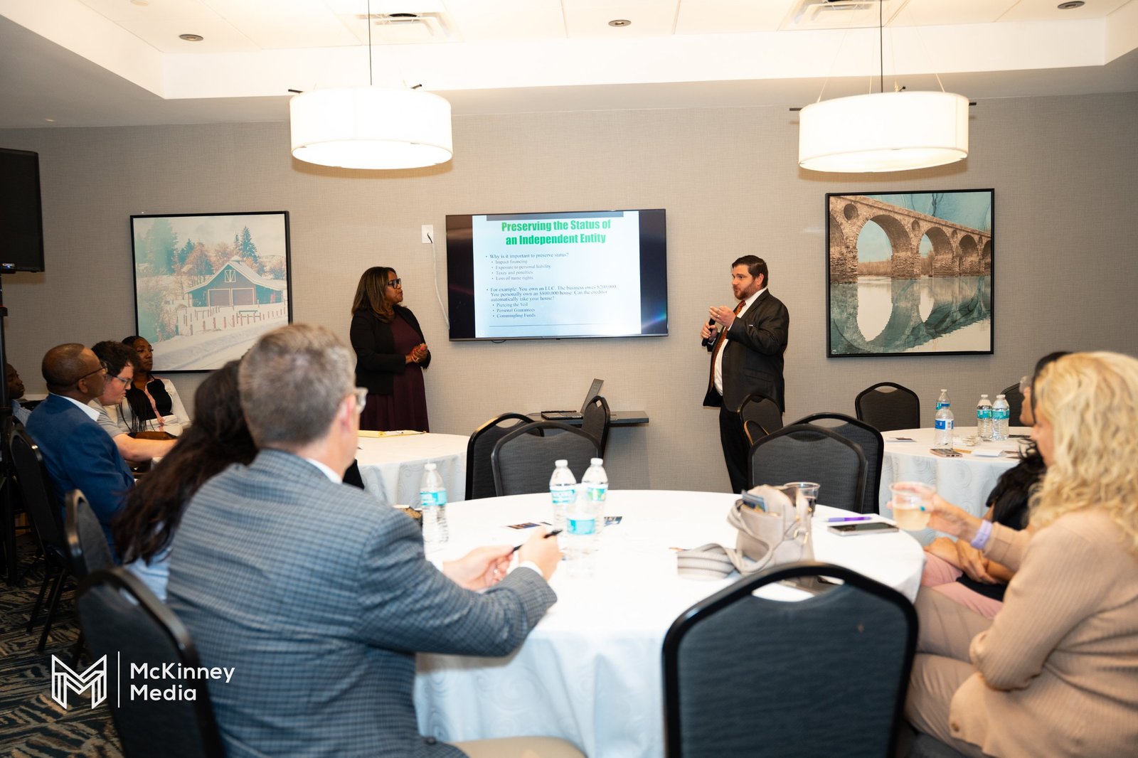 A speaker addresses a small audience at a workshop