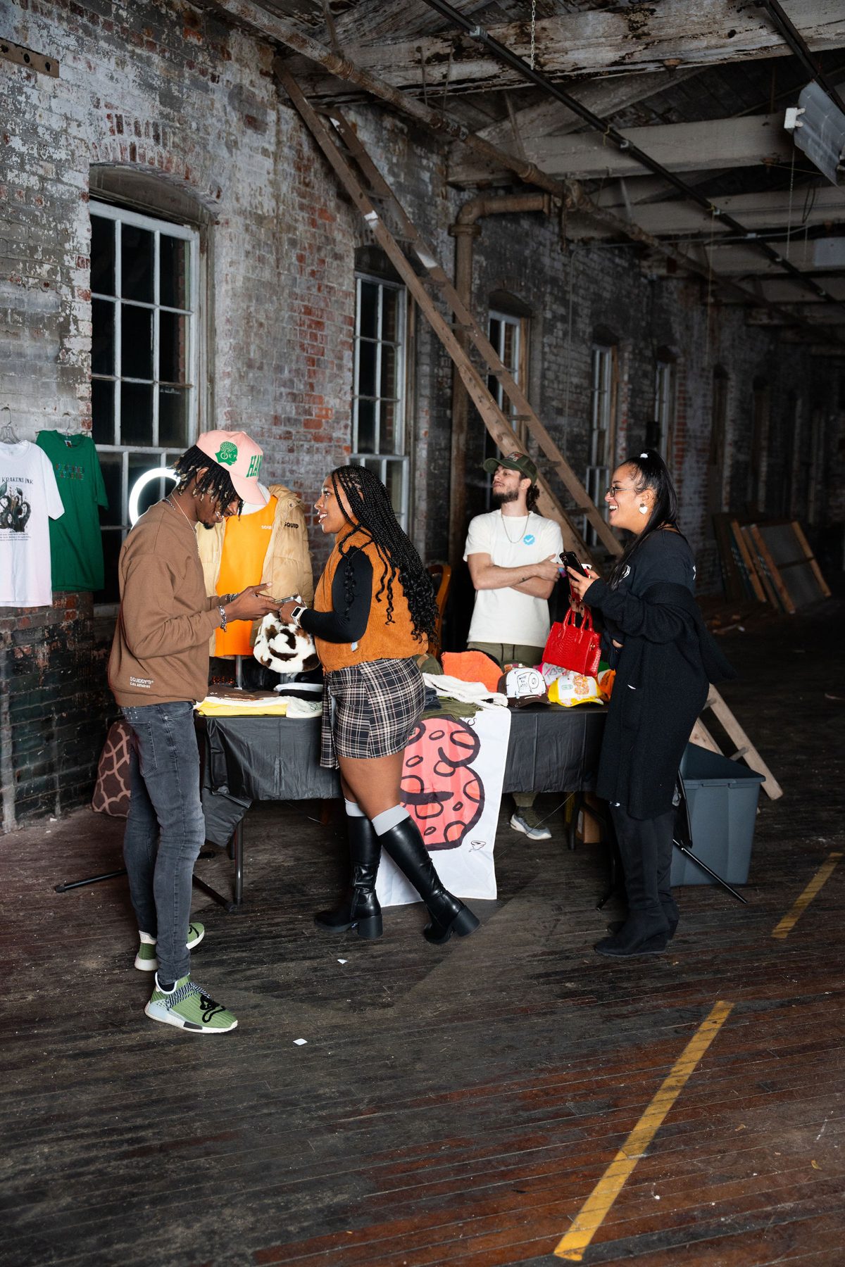 Guests mingling at THEPHOTOPARTY in a brick-walled studio