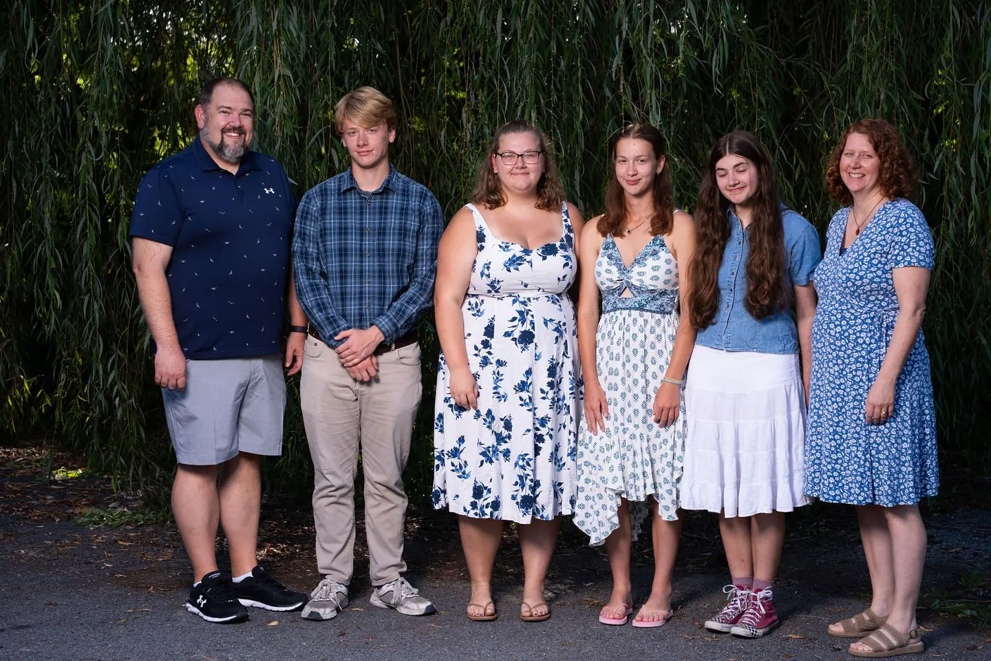 A family poses together outdoors