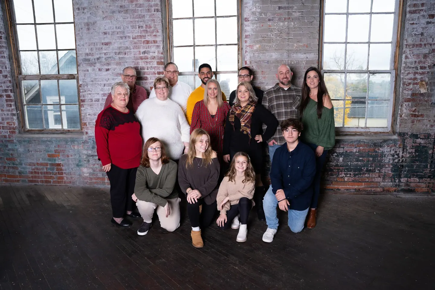 A group of friends poses together outside