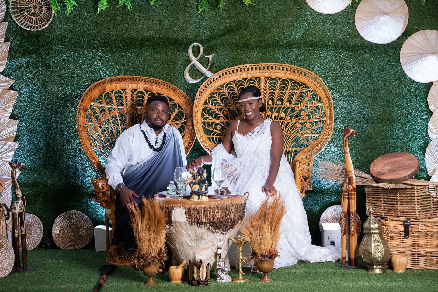 A couple sits together beneath a decorated arch