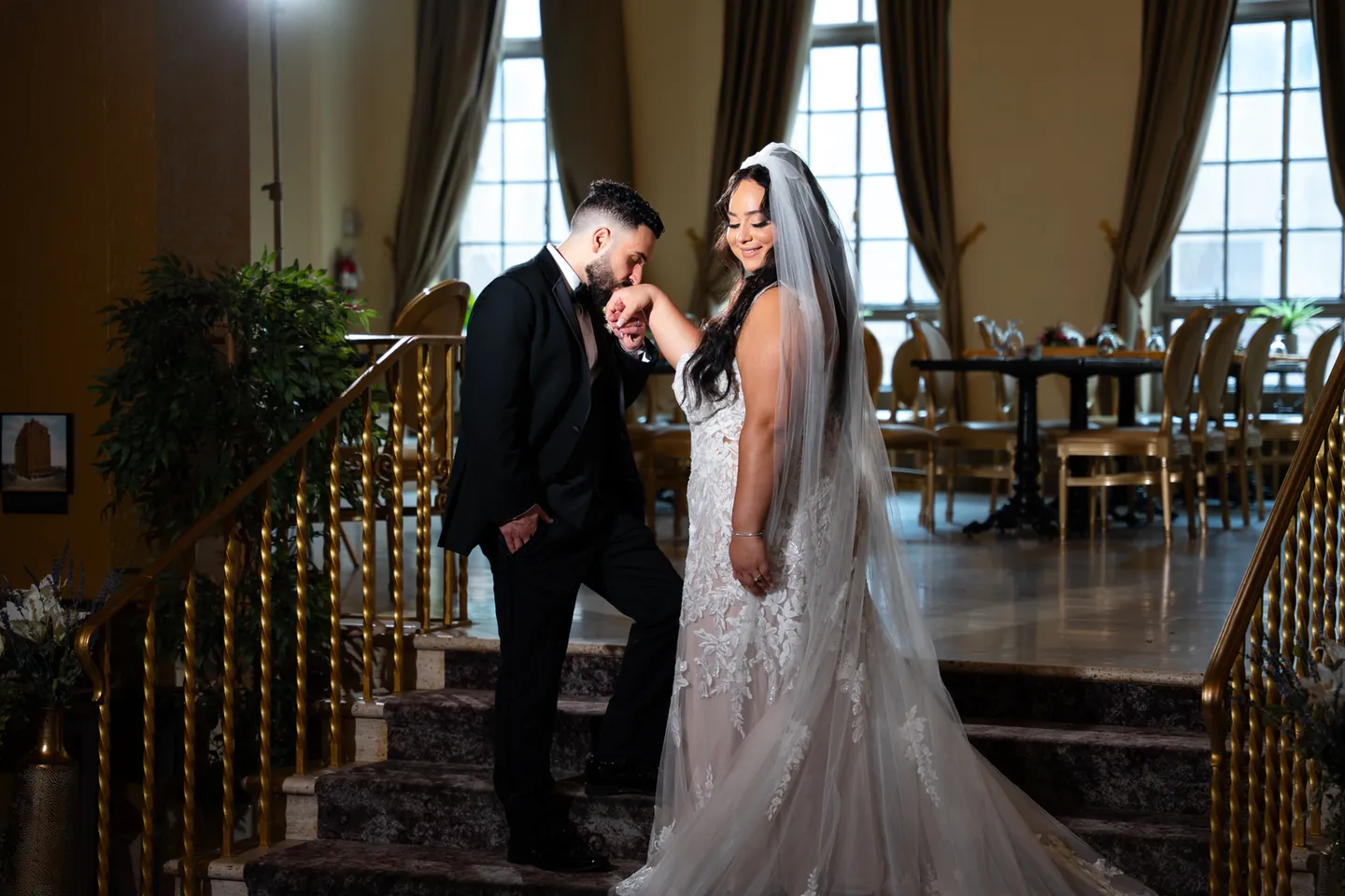 Sam kisses Pauline’s hand on the steps inside the Americus Hotel